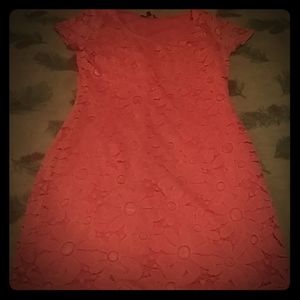 A dress thats pink with an orange tint lase dress